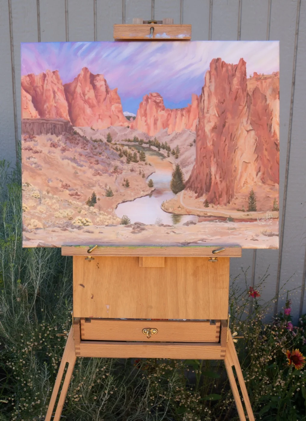 Finished Smith Rock landscape painting on an easel, portrait orientation